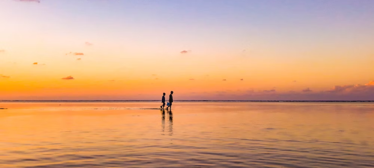 two person standing in sea